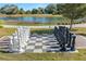 Outdoor chess board with a full set of pieces and a view of a lake and greenery in the background at 12410 Osorio Ct # 201, Sarasota, FL 34238