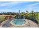 Outdoor hot tub surrounded by beautiful landscaping with lake views at 12410 Osorio Ct # 201, Sarasota, FL 34238