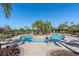 Unique circular pool design with a central island of palm trees and lounge seating at 12410 Osorio Ct # 201, Sarasota, FL 34238