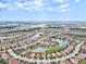 Wide aerial view of a vast neighborhood interspersed with ponds and lakes at 12675 Richezza Dr, Venice, FL 34293