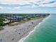 Expansive beach aerial showcases the sandy shoreline, clear waters, and tranquil coastal community at 12675 Richezza Dr, Venice, FL 34293