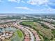 Aerial image of neighborhood surrounded by lakes, ponds and vegetation at 12675 Richezza Dr, Venice, FL 34293