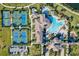 Community aerial view of tennis courts, clubhouse, and resort style pool at 12675 Richezza Dr, Venice, FL 34293