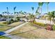 Beautiful entrance to the community with lush landscaping, palm trees, and decorative signage at 12675 Richezza Dr, Venice, FL 34293