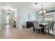 Bright dining area adjacent to the foyer, featuring a chandelier, table, and stylish seating at 12675 Richezza Dr, Venice, FL 34293