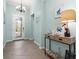 Inviting foyer with decorative lighting, a console table, and neutral tile flooring at 12675 Richezza Dr, Venice, FL 34293