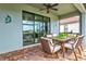 Cozy outdoor dining area with a view of the lush backyard at 12675 Richezza Dr, Venice, FL 34293