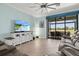 Light-filled living room with tile floors, TV, and screened-in patio at 12675 Richezza Dr, Venice, FL 34293