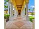 Covered walkway with elegant columns and tiled floor offers a cool path to community ammenities at 12675 Richezza Dr, Venice, FL 34293