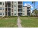 Building exterior with multiple screened lanais, landscaped grounds, and well-maintained pathways at 16904 Vardon Ter # 102, Bradenton, FL 34211