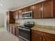 Kitchen with stainless steel appliances, ample cabinet space, and granite countertops at 16904 Vardon Ter # 102, Bradenton, FL 34211