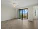 Bright living room with tiled floors and sliding glass doors to the outside patio at 16904 Vardon Ter # 102, Bradenton, FL 34211