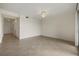 Neutral-toned living room with tiled floors and doorways to bedrooms and kitchen at 16904 Vardon Ter # 102, Bradenton, FL 34211