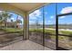 Screened in lanai with brick pavers offering serene lake views and lush landscaping at 16904 Vardon Ter # 102, Bradenton, FL 34211