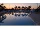 Inviting community pool at sunset with palm trees reflecting in the water at 1863 Palm Springs St, Sarasota, FL 34234