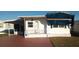 White single-wide manufactured home with carport and covered walkway at 1863 Palm Springs St, Sarasota, FL 34234