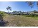 Expansive waterfront backyard featuring a private boat dock and tropical landscaping at 1956 Greenlawn Dr, Englewood, FL 34223