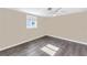 This bedroom has neutral-colored walls, a window with a shade, and dark floors at 1956 Greenlawn Dr, Englewood, FL 34223