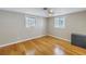 This bedroom features two windows, beautiful floors, and a ceiling fan at 1956 Greenlawn Dr, Englewood, FL 34223