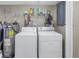 This laundry room has a washer, dryer, and plenty of storage for supplies at 1956 Greenlawn Dr, Englewood, FL 34223