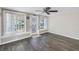 Sunlit living room featuring neutral paint, updated flooring, and access to a covered porch at 1956 Greenlawn Dr, Englewood, FL 34223