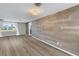 Modern living room featuring hardwood floors, and a contemporary accent wall at 1956 Greenlawn Dr, Englewood, FL 34223