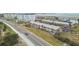 Scenic aerial view of residential buildings, a road, and waterfront property showcasing the area's beauty at 2 Causeway Blvd # 206, Dunedin, FL 34698