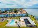 Aerial view of waterfront condos, community pool, and landscaped grounds at 2 Causeway Blvd # 206, Dunedin, FL 34698