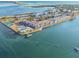 Breathtaking aerial view of waterfront condo complex with tennis courts and a swimming pool at 2 Causeway Blvd # 206, Dunedin, FL 34698