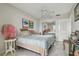 Bedroom featuring tile floors, mirrored closet, ceiling fan and ample light at 2 Causeway Blvd # 206, Dunedin, FL 34698