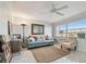 Living room with tile floors, modern decor, ceiling fan, and natural light at 2 Causeway Blvd # 206, Dunedin, FL 34698