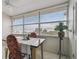 Bright sunroom with large windows offering serene views of the water and sky at 2 Causeway Blvd # 206, Dunedin, FL 34698