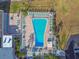 Aerial shot of the community pool area featuring a unique pool shape, lounge chairs, and manicured landscaping at 2 Causeway Blvd # 206, Dunedin, FL 34698