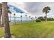 Enjoy a game of tennis on this beautiful, palm-lined court with views of the water at 2 Causeway Blvd # 206, Dunedin, FL 34698