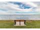 Relax on this bench and take in the stunning, panoramic water view at 2 Causeway Blvd # 206, Dunedin, FL 34698