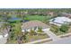 Aerial view of a beautiful home with a large, well-manicured lawn and a scenic view at 2023 Micanopy Trl, Nokomis, FL 34275