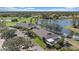 Aerial view of a community center situated on a lake and a golf course at 2023 Micanopy Trl, Nokomis, FL 34275