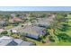 Aerial view of a lovely home with a screen enclosed pool and spa situated on a golf course at 2023 Micanopy Trl, Nokomis, FL 34275