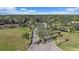 A long driveway leads to luxurious estates amidst lush landscaping, palms, and scenic water features at 2023 Micanopy Trl, Nokomis, FL 34275