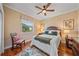 Cozy bedroom with hardwood floors, plush bedding, and a large window at 2023 Micanopy Trl, Nokomis, FL 34275