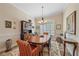 Traditional dining room with an oval table, china cabinet, and bright window with plantation shutters at 2023 Micanopy Trl, Nokomis, FL 34275