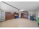 Well organized garage with epoxy flooring, cabinets, shelving, and tool storage at 2023 Micanopy Trl, Nokomis, FL 34275