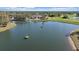 Aerial view of a lake on a golf course featuring floating targets and beautifully manicured landscaping at 2023 Micanopy Trl, Nokomis, FL 34275