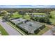 Aerial view of community tennis courts with lush landscaping and golf course in background at 2023 Micanopy Trl, Nokomis, FL 34275