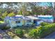 Single story house with green exterior, tree-lined street at 2040 Palm Ter, Sarasota, FL 34231