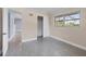 Simple bedroom with neutral walls, new flooring, and a sliding door closet at 2040 Palm Ter, Sarasota, FL 34231