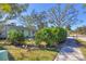 House with green exterior and manicured hedges along sidewalk at 2040 Palm Ter, Sarasota, FL 34231