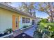 House entrance with light green exterior and yellow door at 2040 Palm Ter, Sarasota, FL 34231