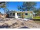 Charming yellow house with a spacious backyard and gravel at 2040 Palm Ter, Sarasota, FL 34231