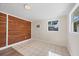 Laundry area with wood-paneled accent wall and tile flooring at 2040 Palm Ter, Sarasota, FL 34231